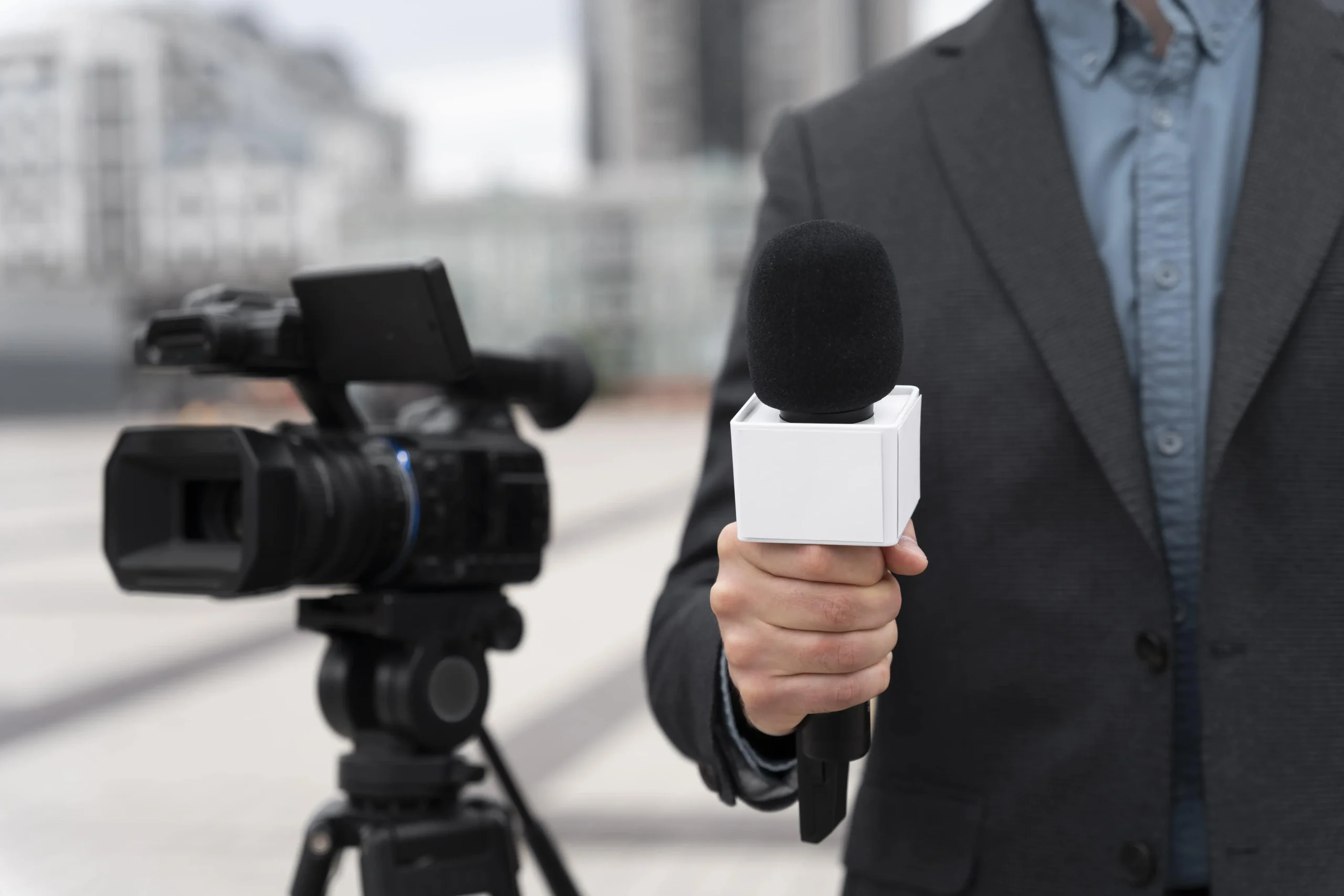Front view journalist holding microphone min 1 scaled