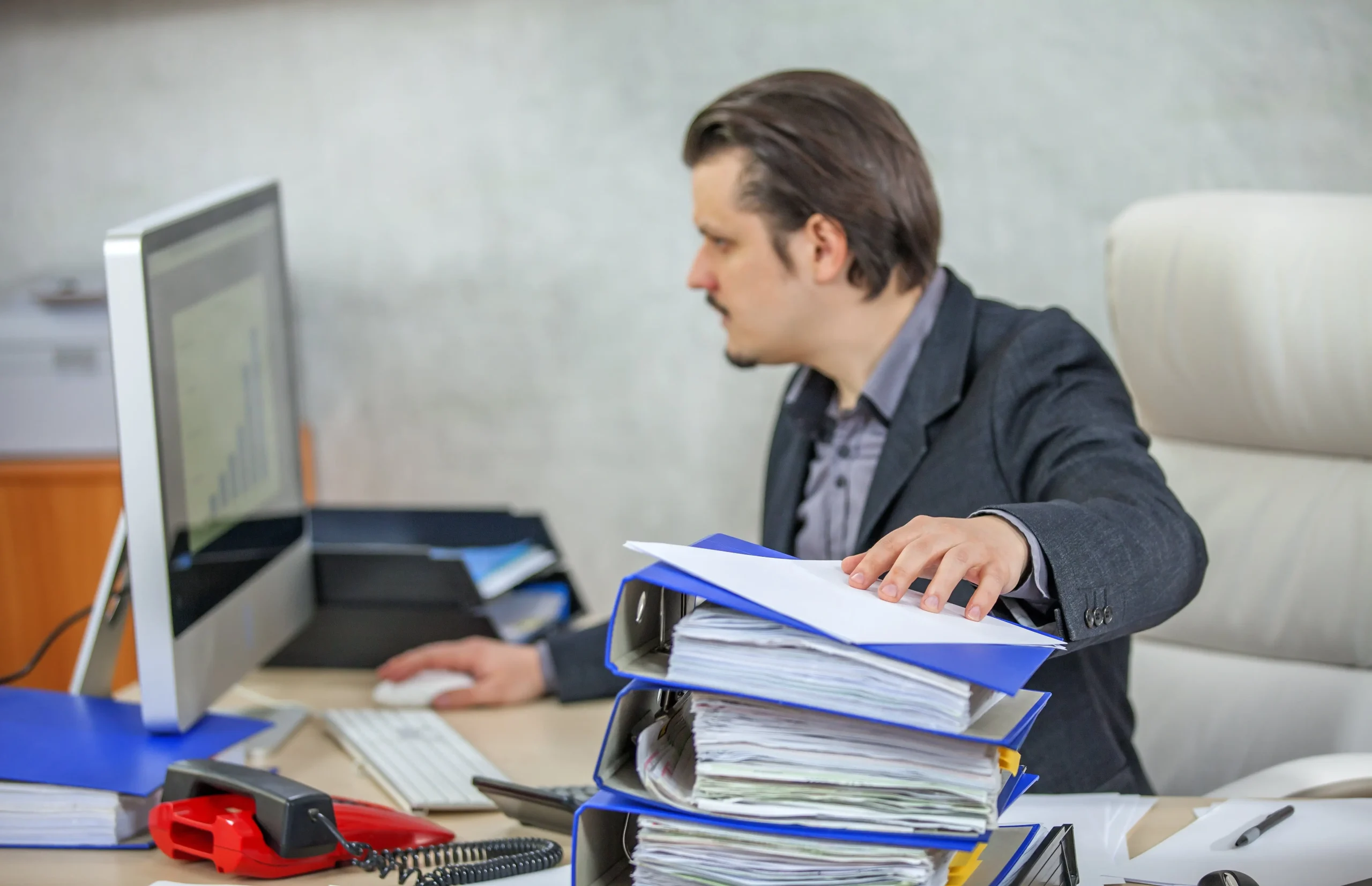 Young businessman working from his office min 1 scaled